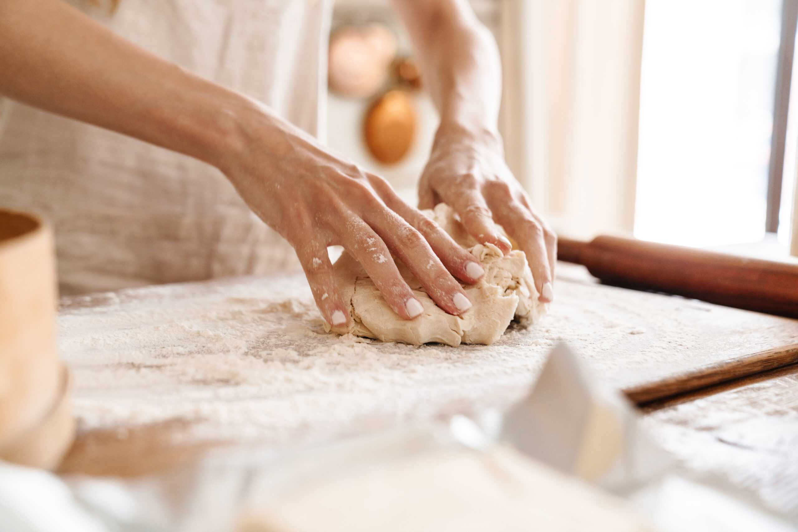 Close up of a young girl baking at the kitchen